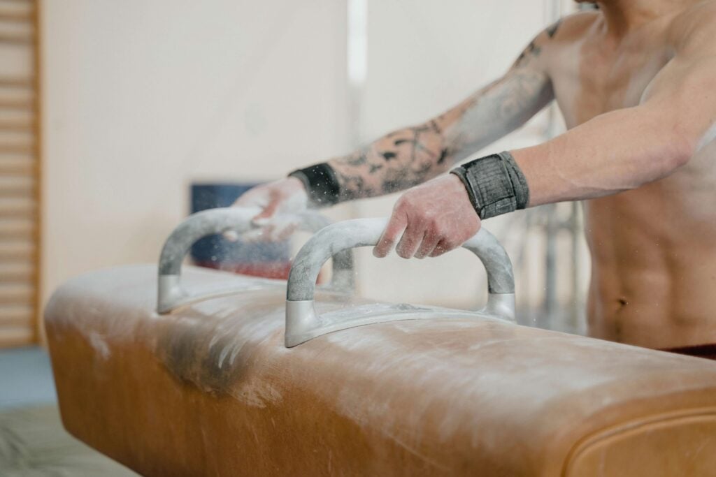 Close-up of hands grabbing a beam