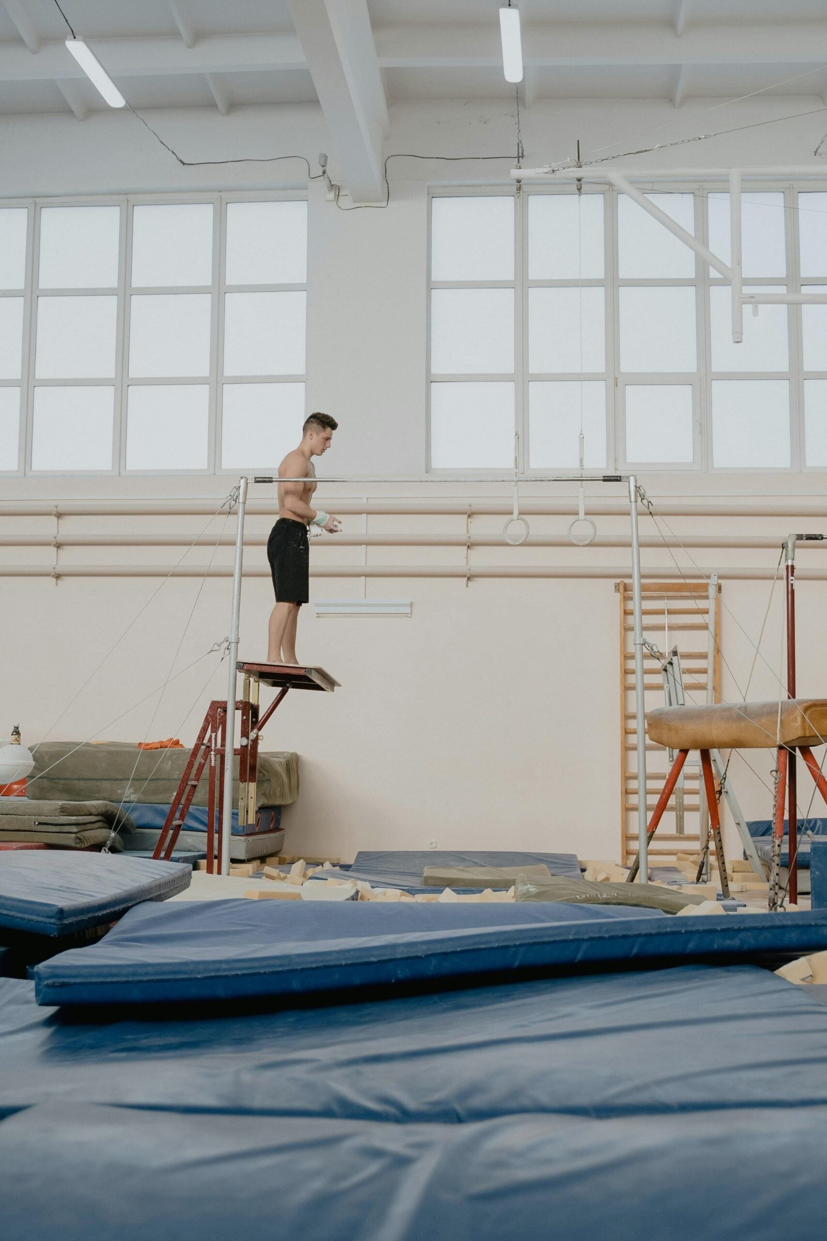 Gymnast balancing on a practice beam in a gym