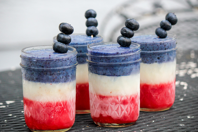 Patriotic berry protein smoothie, a refreshing red, white, and blue beverage.