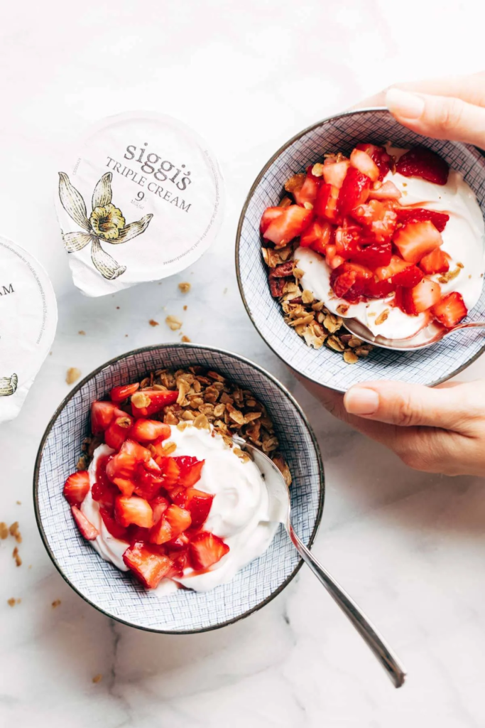 Yogurt parfait with fresh strawberries and granola, a healthy and delicious breakfast or snack option.